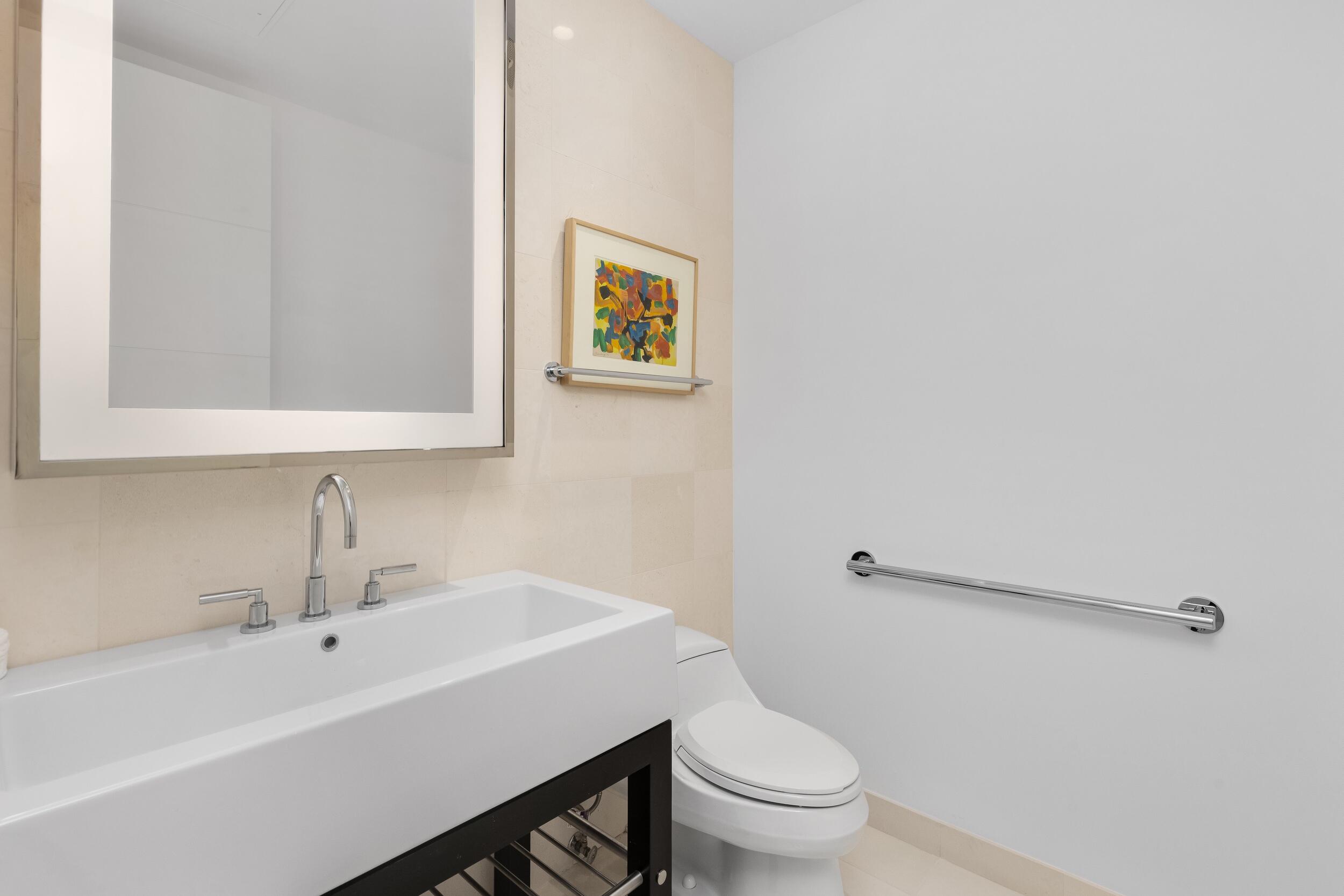 1000 South Ocean Boulevard, Unit 601 Boca Raton, FL 33432 - Photo 38 of 54 a bathroom with a sink mirror and toilet