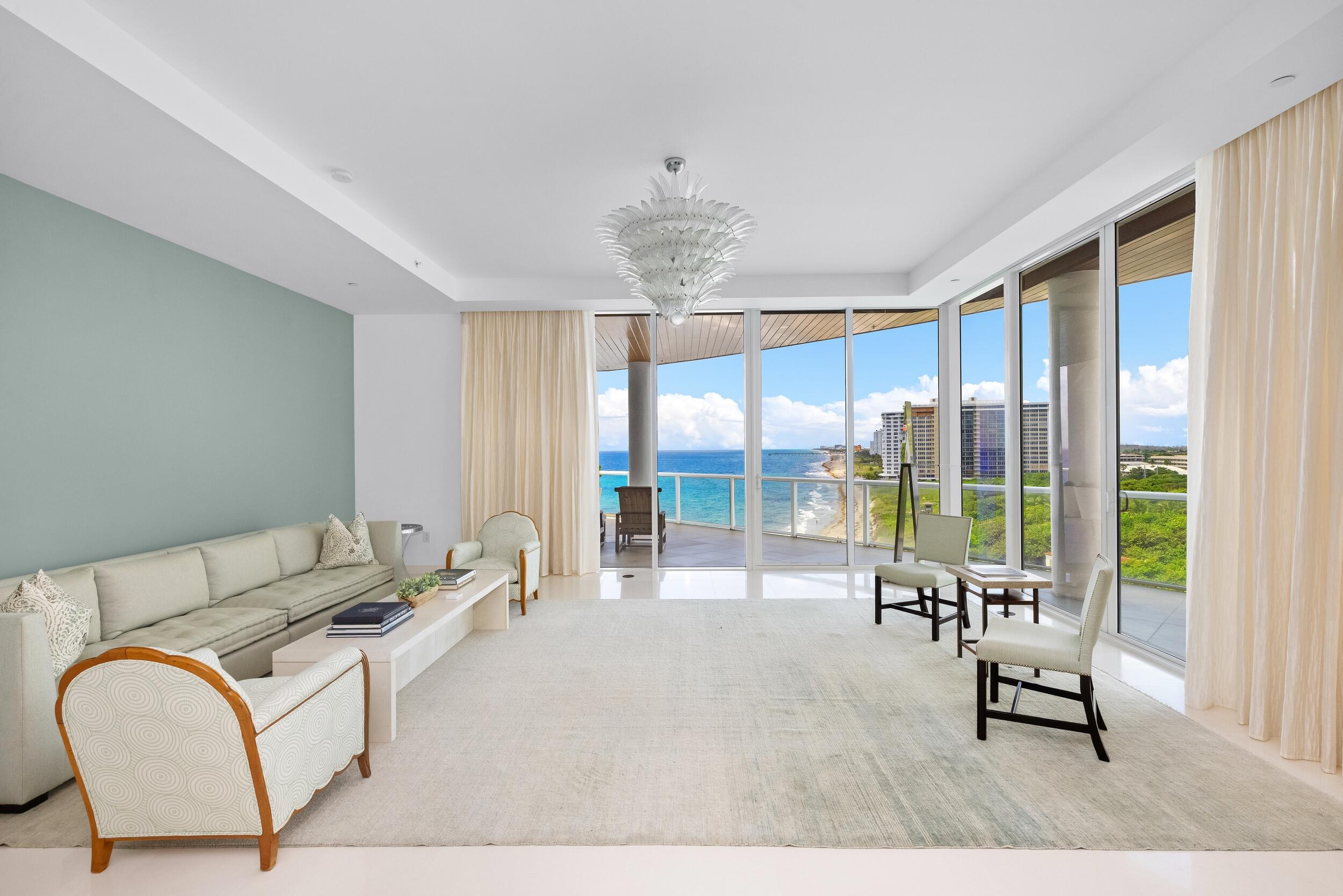 1000 South Ocean Boulevard, Unit 601 Boca Raton, FL 33432 - Photo 7 of 54 a living room with furniture and floor to ceiling windows