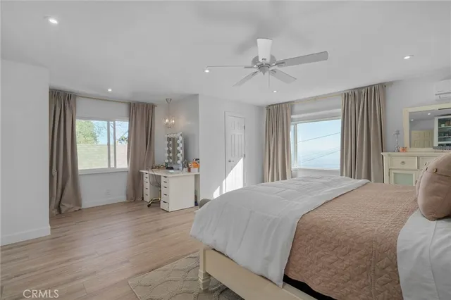 a view of a workspace with furniture and wooden floor