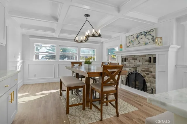 a kitchen with a dining table chairs sink and stove