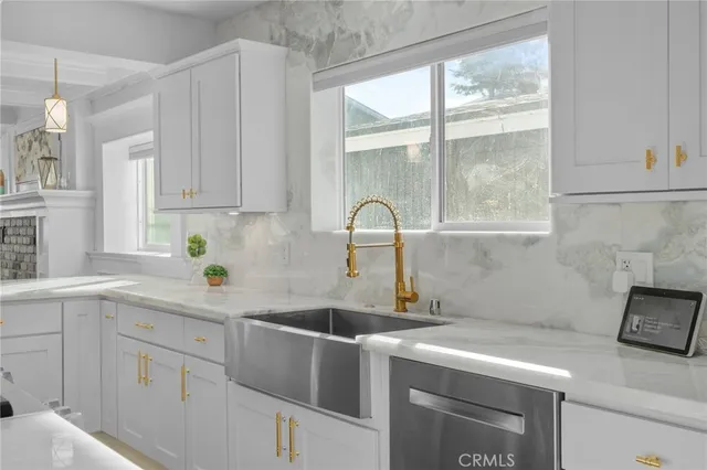 a living room with furniture and kitchen view