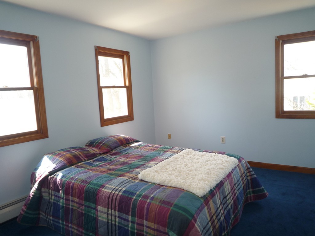 100 Highcrest Road Fall River, MA 02720 - Photo 25 of 30 a bedroom with a bed a window and potted plant