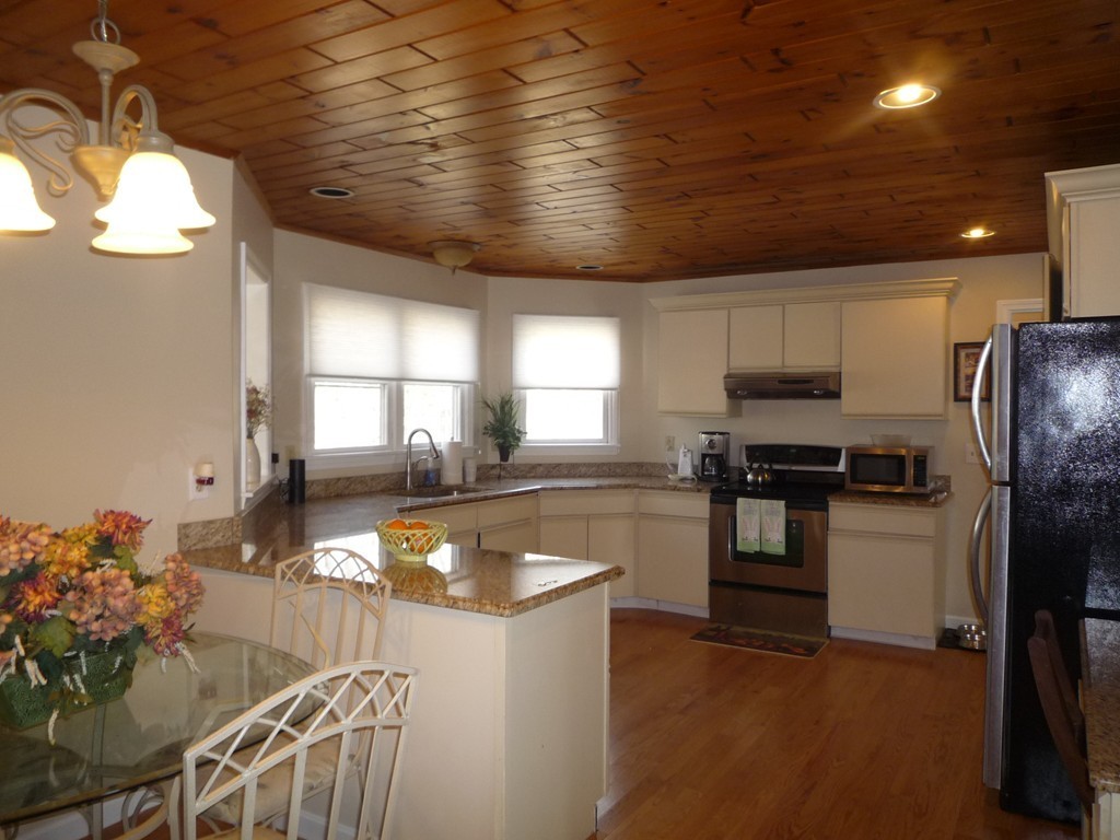100 Highcrest Road Fall River, MA 02720 - Photo 5 of 30 a kitchen with stainless steel appliances granite countertop a sink a stove cabinets counter space and a window
