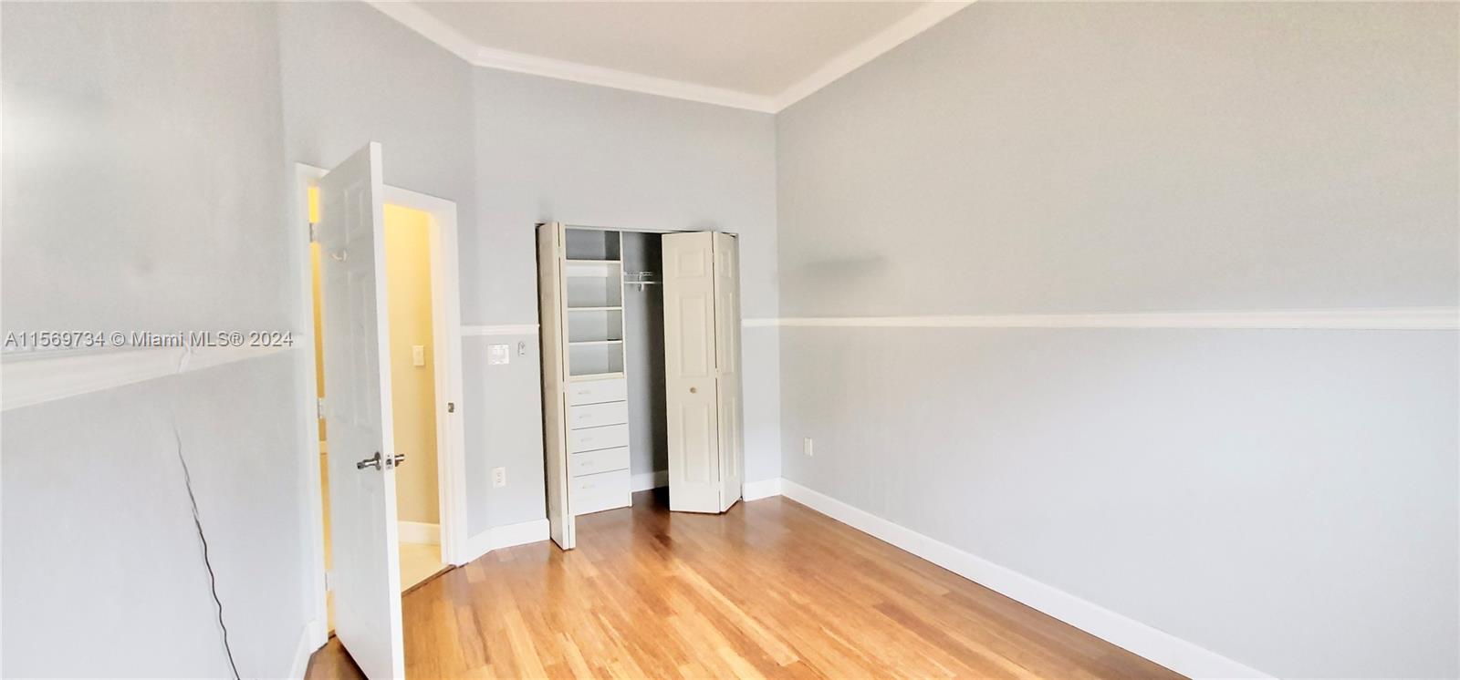 16519 Ruby Lake, Unit 16519 Weston, FL 33331 - Photo 13 of 24 a view of a bedroom with wooden floor and bathroom