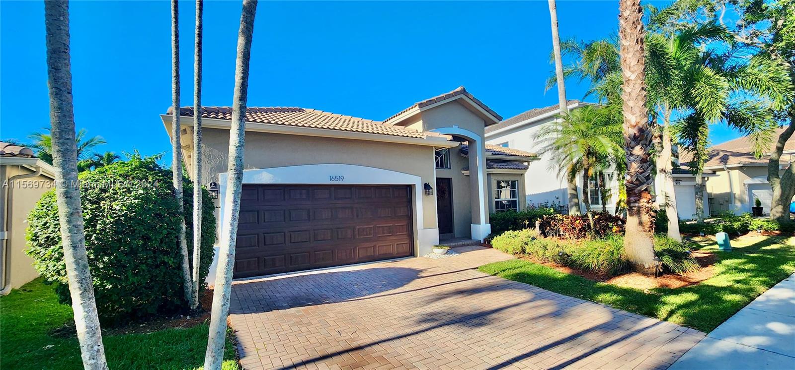 16519 Ruby Lake, Unit 16519 Weston, FL 33331 - Photo 16 of 24 a front view of a house with garden