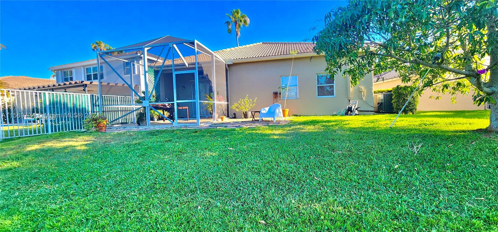 16519 Ruby Lake, Unit 16519 Weston, FL 33331 - Photo 17 of 24 a front view of a house with a yard and trees