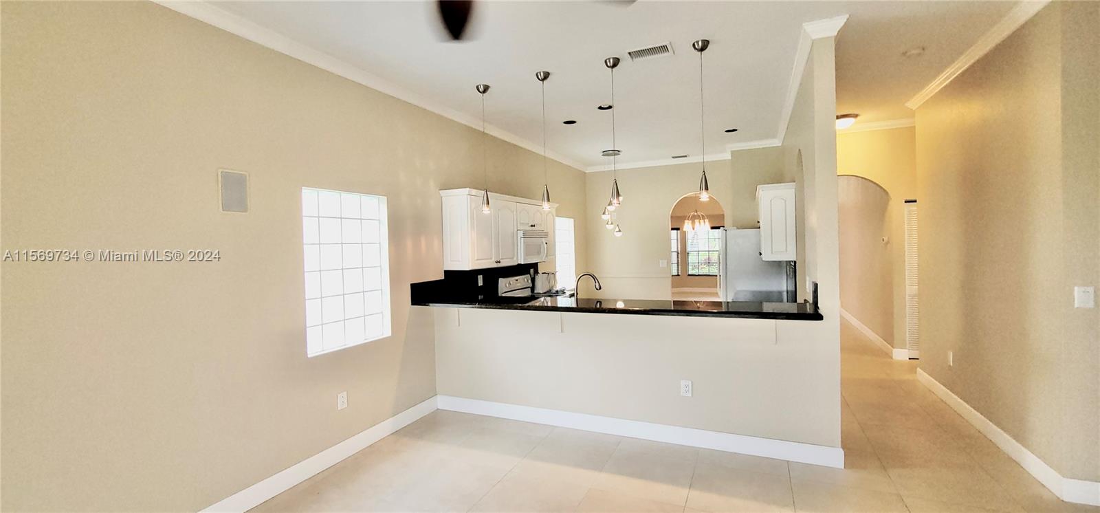 16519 Ruby Lake, Unit 16519 Weston, FL 33331 - Photo 5 of 24 a large white kitchen with a large window
