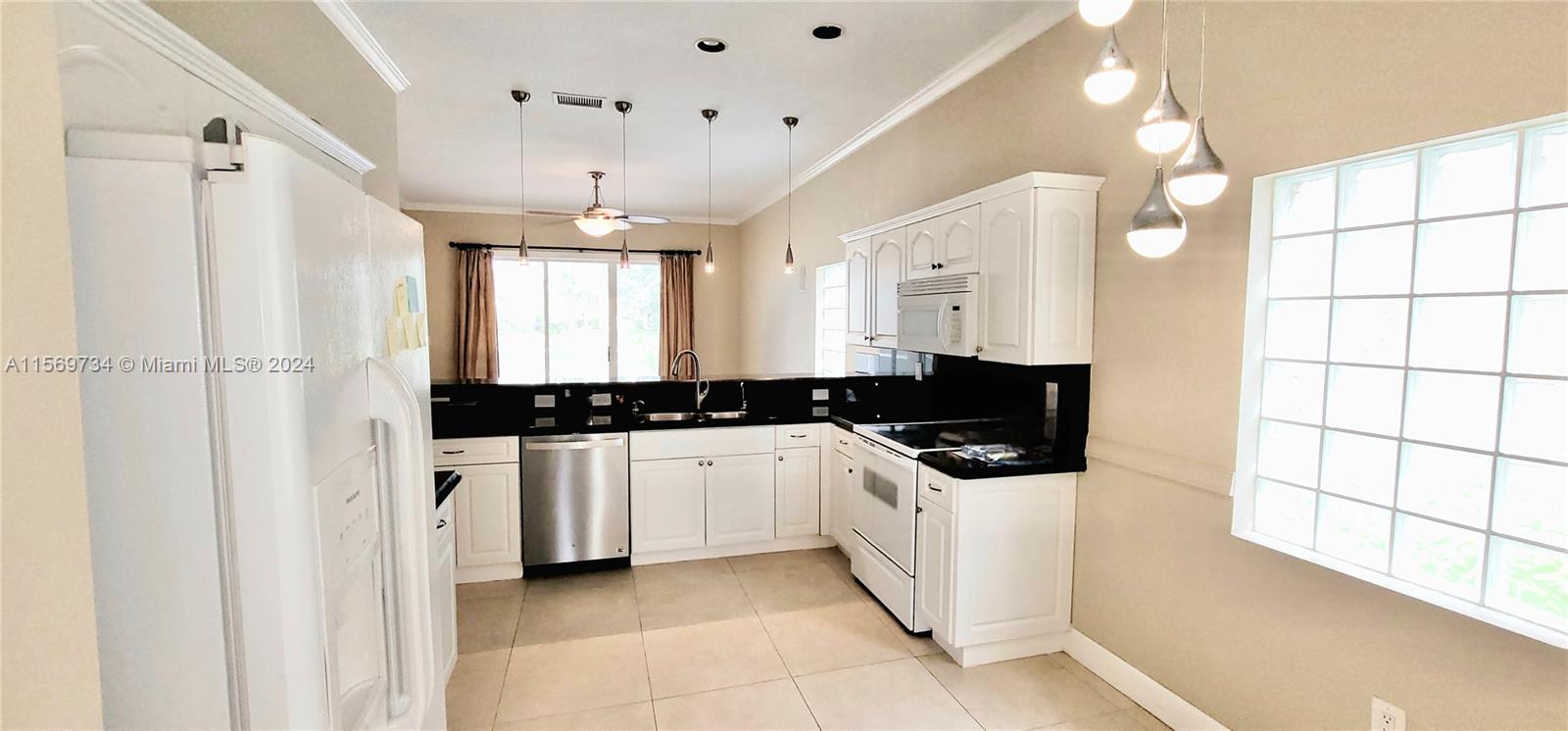 16519 Ruby Lake, Unit 16519 Weston, FL 33331 - Photo 6 of 24 a kitchen with stainless steel appliances a sink stove and cabinets