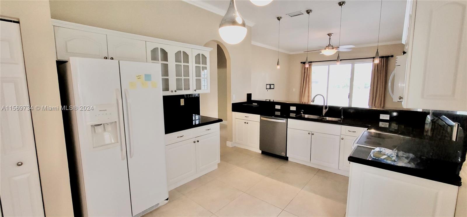 16519 Ruby Lake, Unit 16519 Weston, FL 33331 - Photo 7 of 24 a kitchen with stainless steel appliances a refrigerator sink and white cabinets