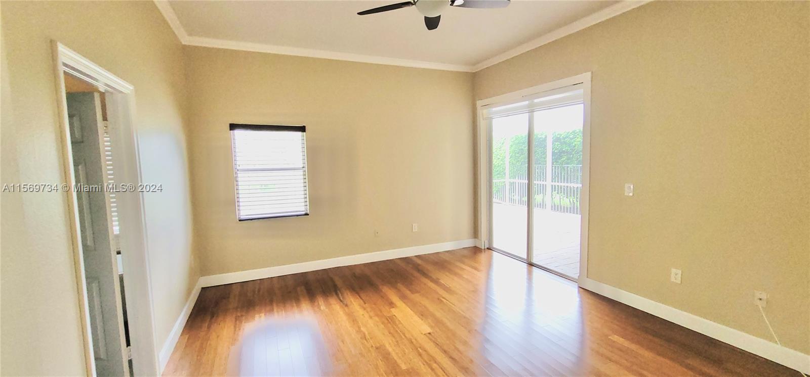 16519 Ruby Lake, Unit 16519 Weston, FL 33331 - Photo 8 of 24 a view of empty room with wooden floor and fan