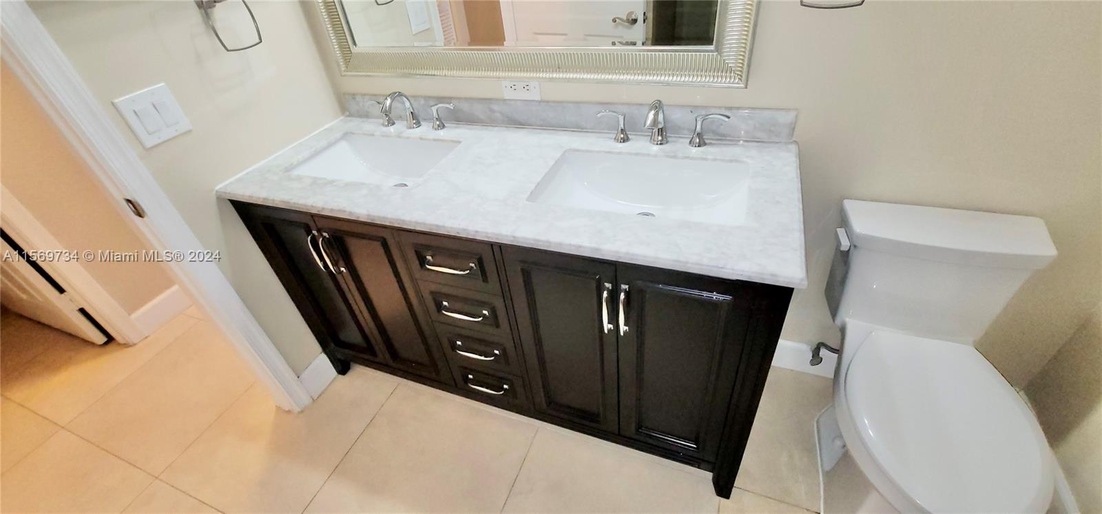 16519 Ruby Lake, Unit 16519 Weston, FL 33331 - Photo 9 of 24 a bathroom with a sink a toilet and a mirror