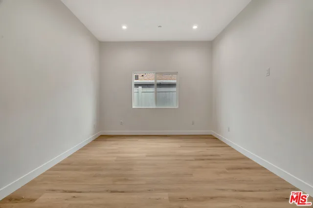 a view of a kitchen with a sink and a refrigerator