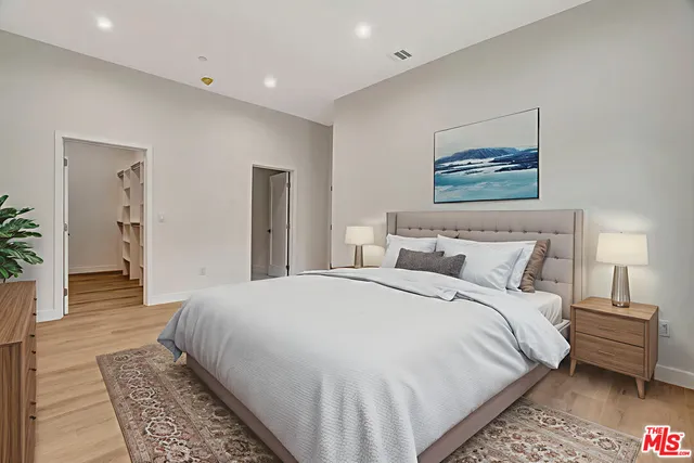 a kitchen with granite countertop white cabinets and stainless steel appliances