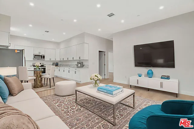 a kitchen with granite countertop white cabinets and stainless steel appliances