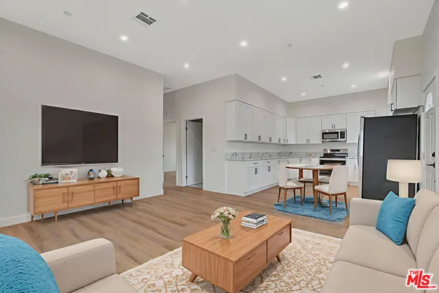 a kitchen with stainless steel appliances granite countertop a refrigerator stove and sink