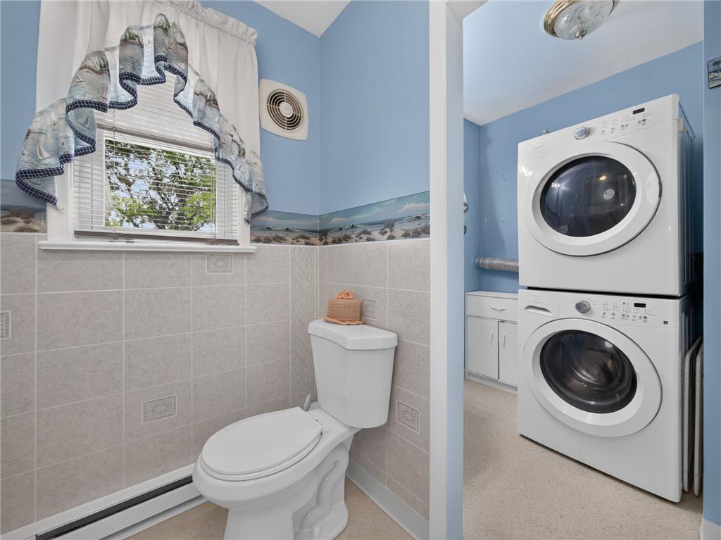 3046 Ridon Court Bethlehem, PA 18020 - Photo 23 of 41 A well-appointed laundry area combines convenience with a functional half-bath, featuring stacked appliances and durable tile flooring.
