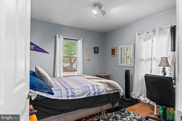 a bedroom with a bed chair and window