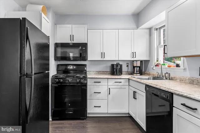 a kitchen with cabinets stainless steel appliances and a counter space