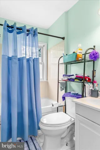 a bathroom with a sink mirror vanity and toilet