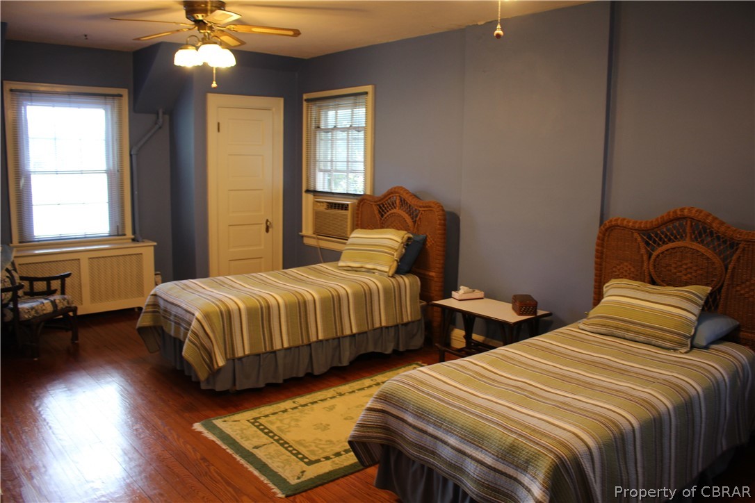 331 Thurston Road Mathews, VA 23109 - Photo 30 of 50 a bedroom with two beds and a chandelier