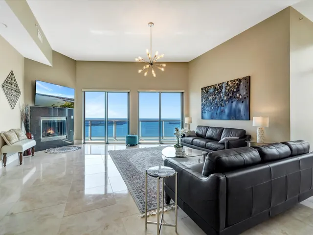 a living room with furniture and a chandelier