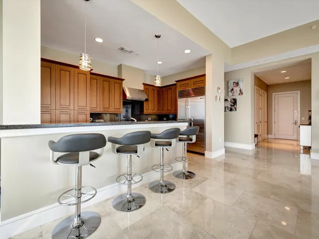 a kitchen with stainless steel appliances kitchen island granite countertop a sink and cabinets