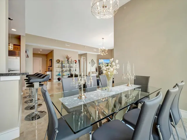 a dining room with furniture and a chandelier