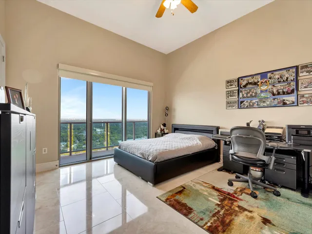 a bedroom with a bed and large window