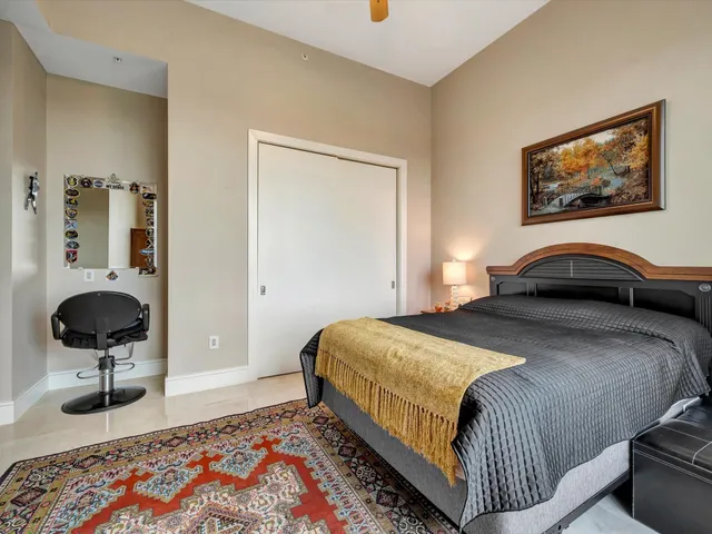 a bedroom with a bed and glass door
