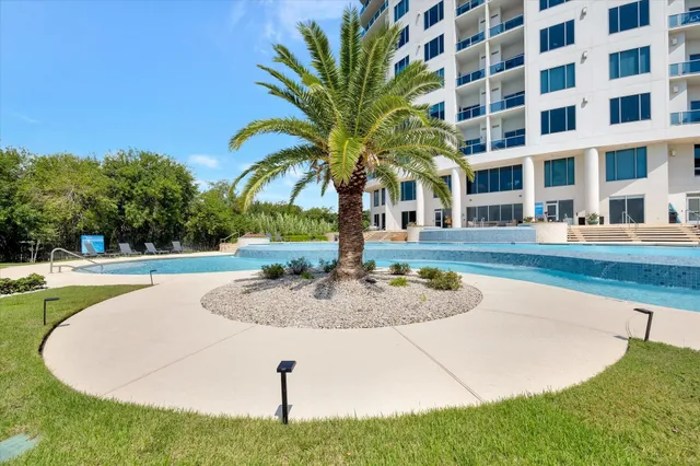 a swimming pool with outdoor seating and yard