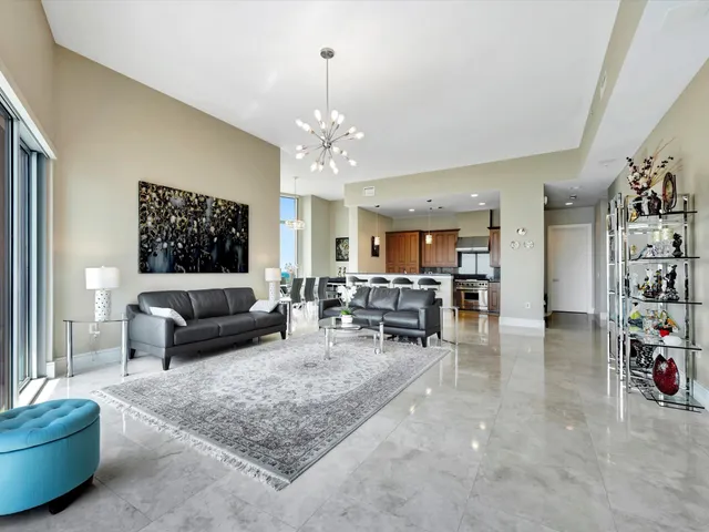 a living room with furniture and kitchen view