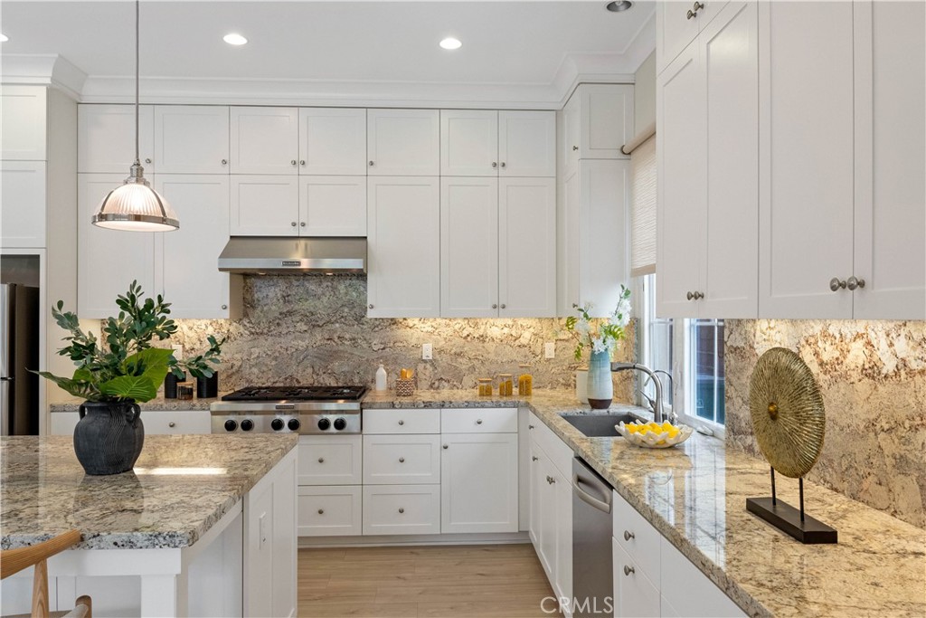 73 Copper Mine Irvine, CA 92602 - Photo 13 of 35 a kitchen with a sink a stove and cabinets