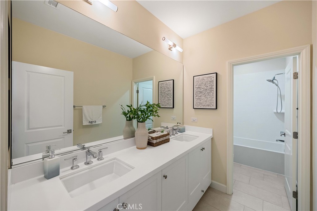 73 Copper Mine Irvine, CA 92602 - Photo 29 of 35 a bathroom with a double vanity sink mirror and shower