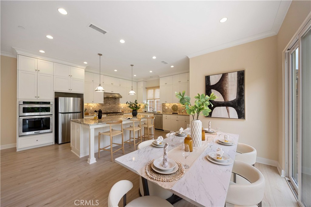 73 Copper Mine Irvine, CA 92602 - Photo 7 of 35 a open dining room with furniture wooden floor and kitchen view