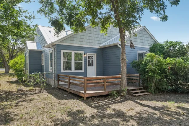 a wooden bench sitting in front of a house