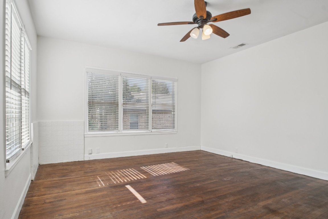 308 Taylor Road Elgin, TX 78621 - Photo 7 of 29 Spare room featuring dark wood-style floors and ceiling fan