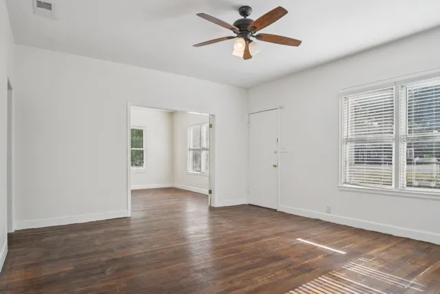 a view of a livingroom with a ceiling fan and window