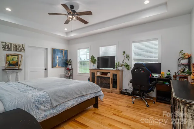 a bedroom with a bed a chair and piano