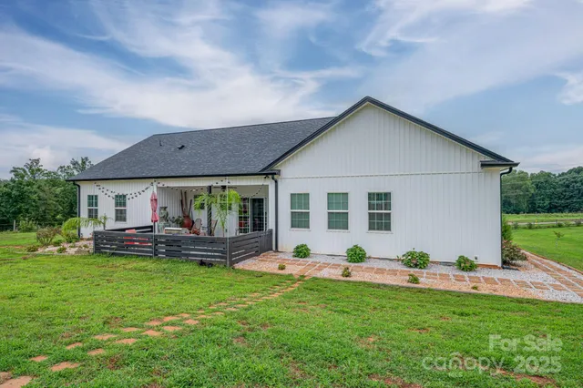 a view of a house with a backyard and sitting area