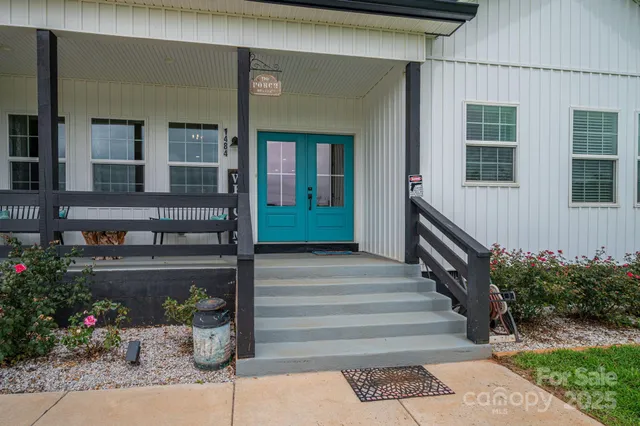 a front view of a house with plants