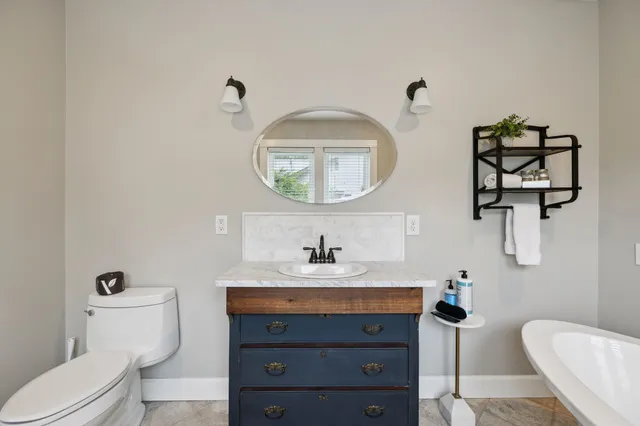 a bedroom with bed and wooden floor