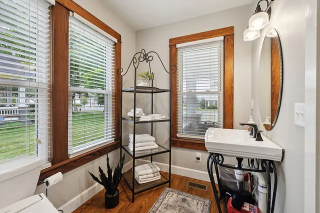 a bathroom with a toilet a sink and mirror