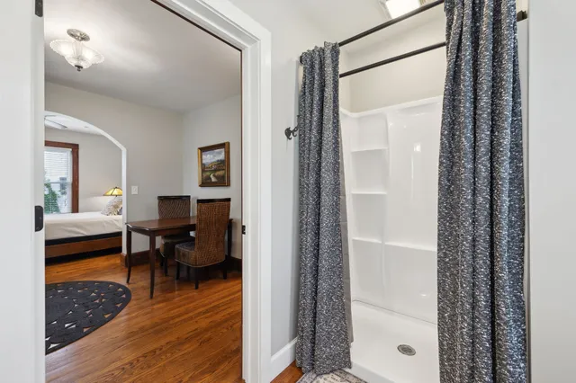 a bedroom with a bed and large windows