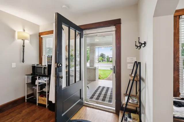 a view of a dining room with furniture a chandelier and wooden floor