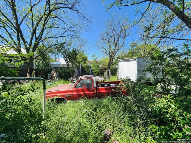 a view of a yard with swimming pool and sitting area