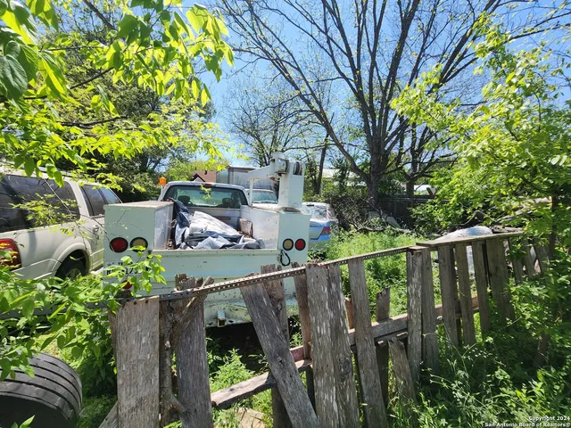 a view of a house with wooden fence