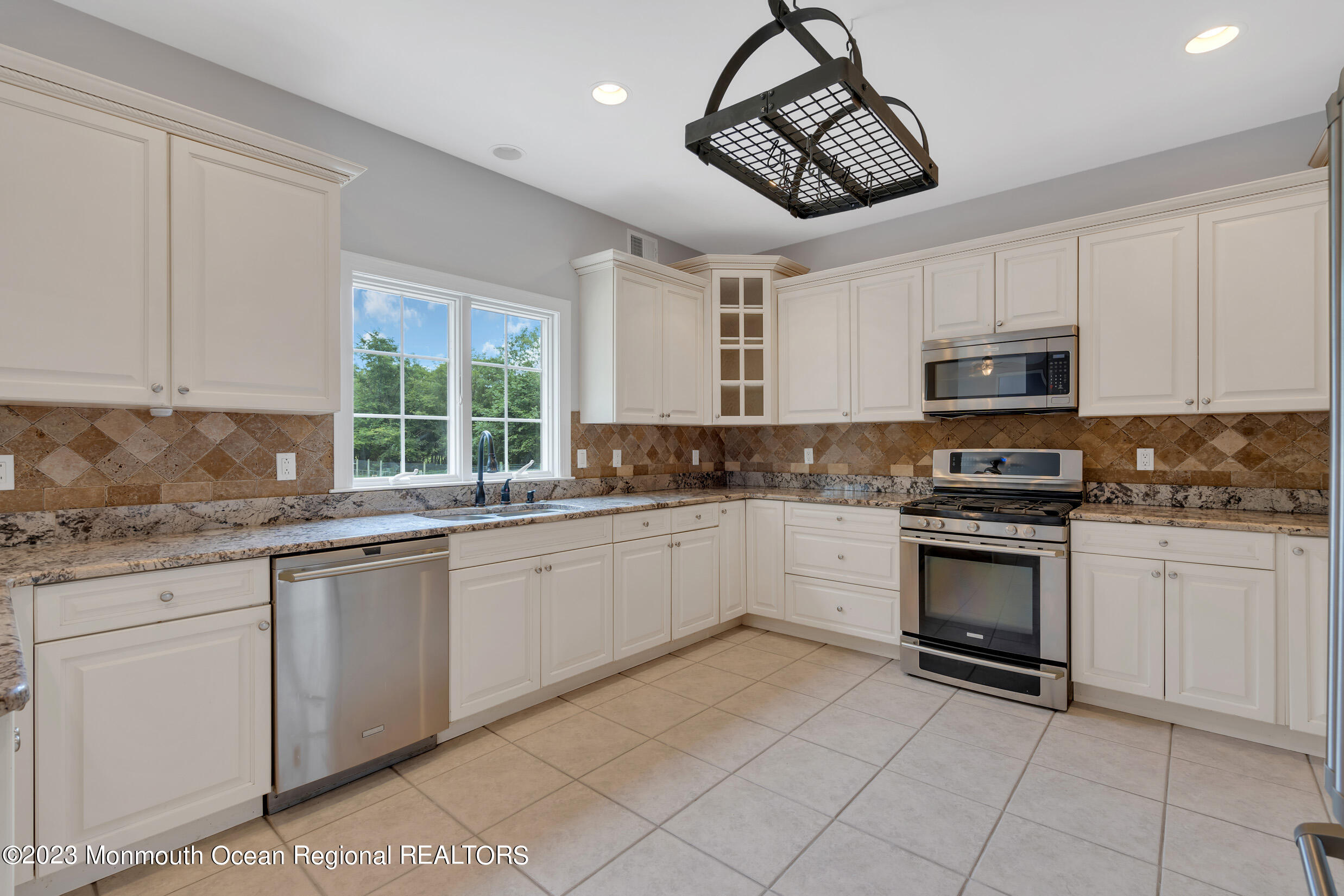 990 Farmingdale Road Jackson, NJ 08527 - Photo 13 of 67 a kitchen with granite countertop cabinets stainless steel appliances a sink and a window