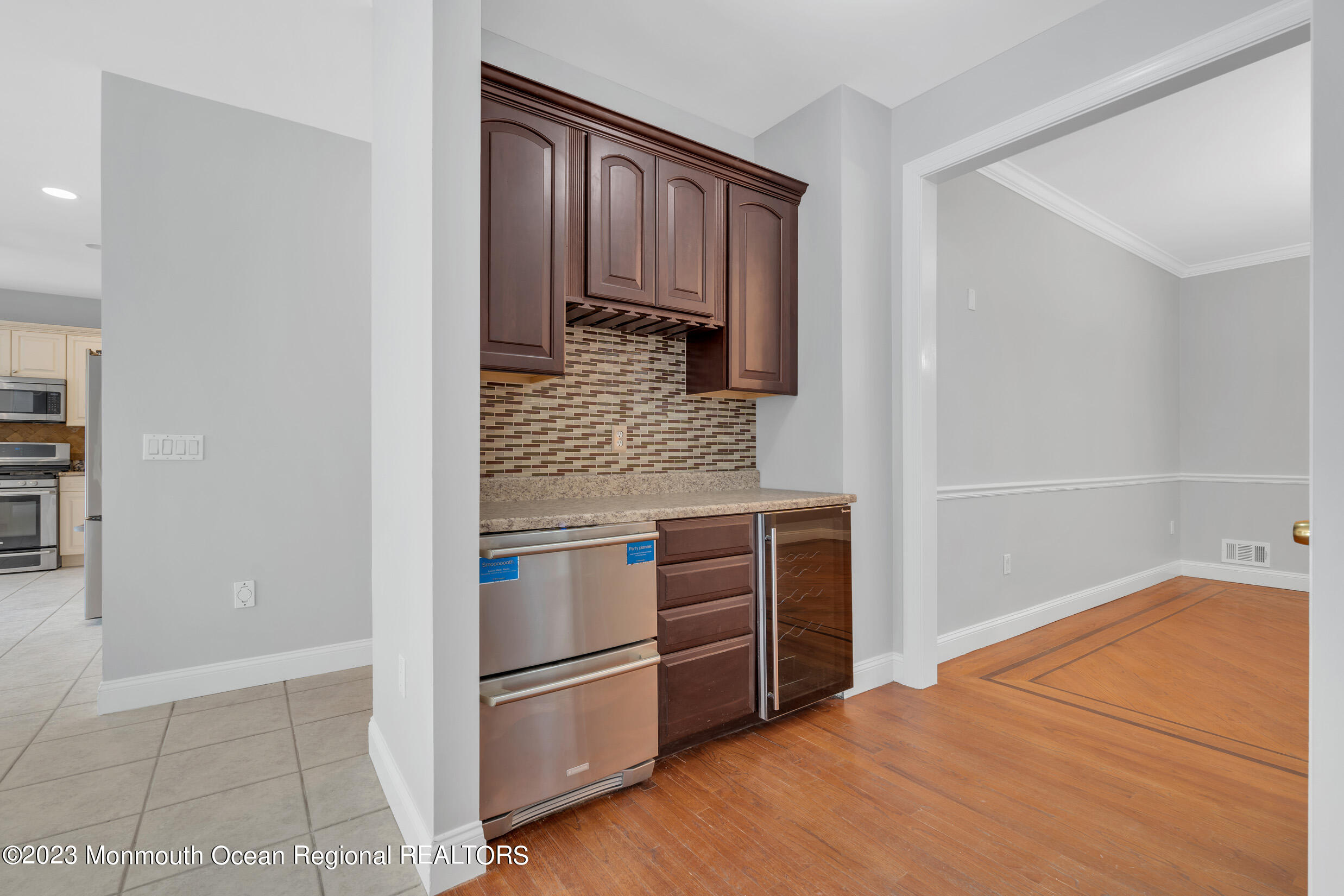 990 Farmingdale Road Jackson, NJ 08527 - Photo 7 of 67 a kitchen with wooden cabinets and a stove top oven