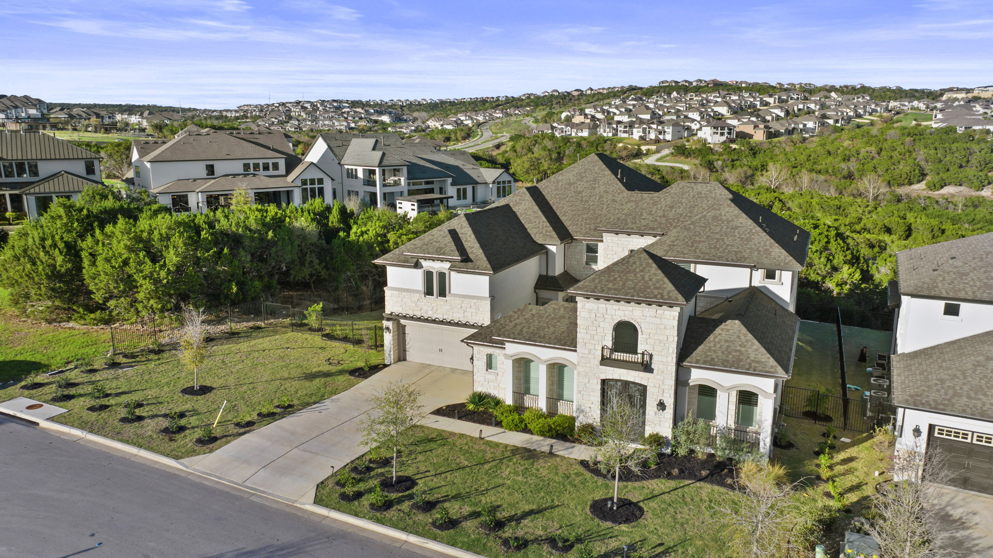 2132 Novara Trail Leander, TX 78641 - Photo 1 of 40 View of front of home with a residential view, stone siding, driveway, and a shingled roof