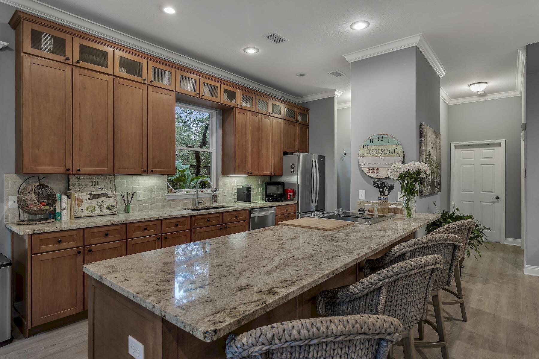304 Wilderness Way Santa Rosa Beach, FL 32459 - Photo 18 of 48 a kitchen with granite countertop cabinets table and chairs